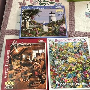 Three 1000 piece puzzles that have been put together once.